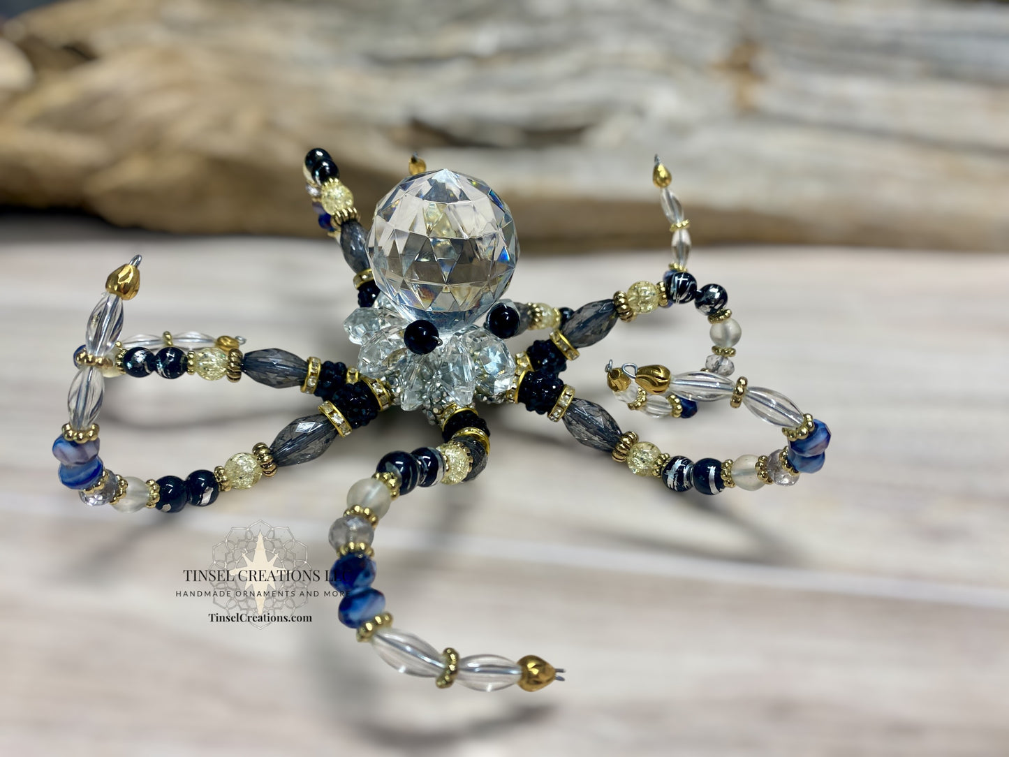 Beaded octopus with crystal ball on a wooden surface