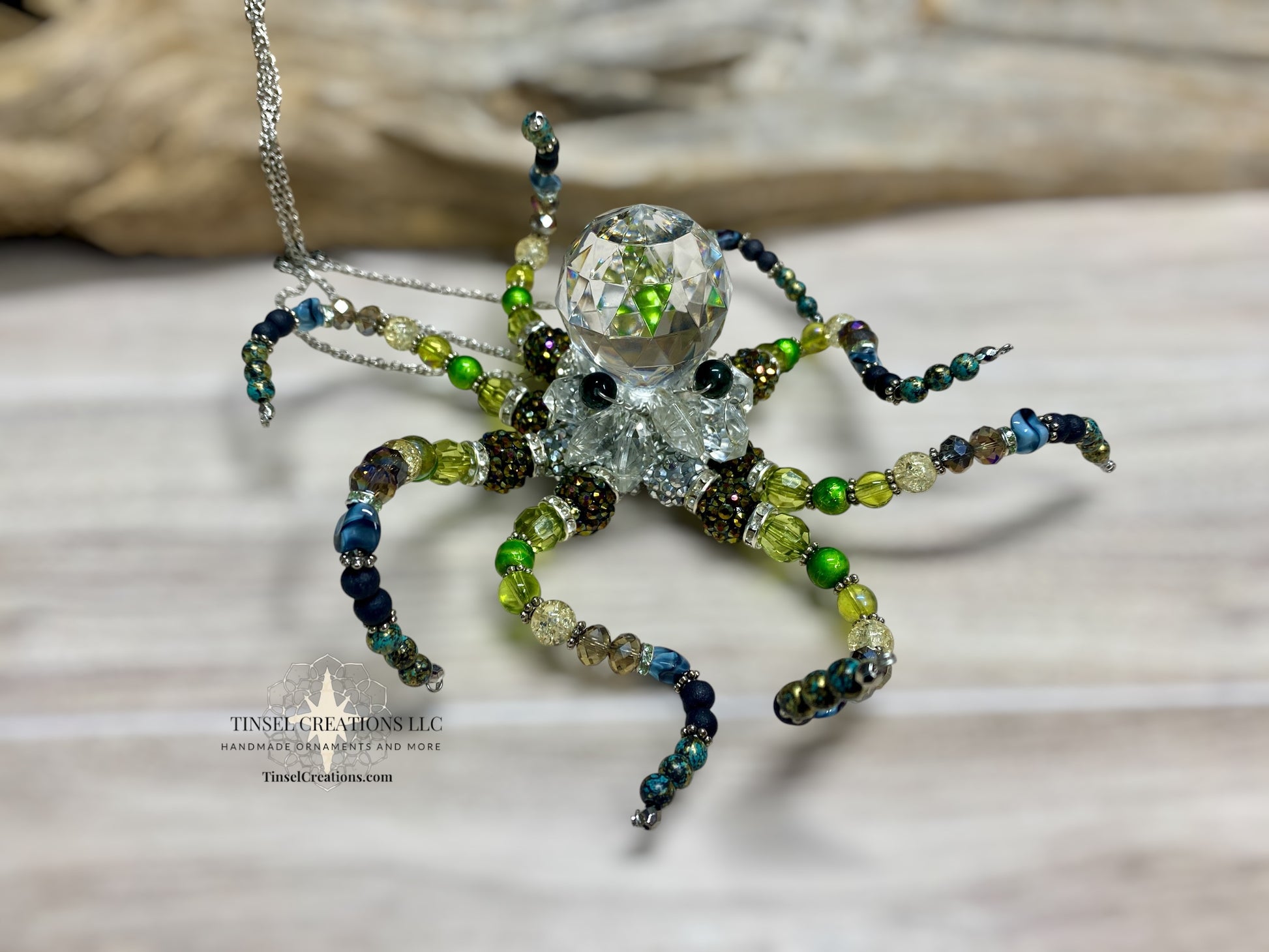 Beaded octopus suncatcher with crystal center on a neutral background