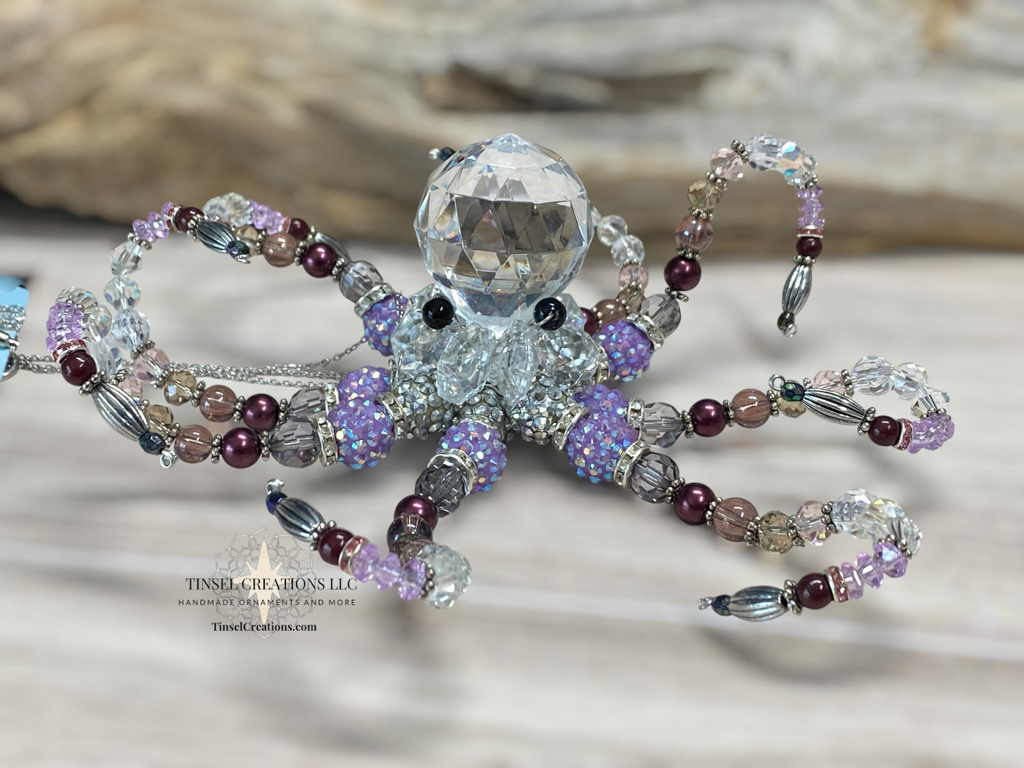 Decorative octopus ornament with bead detailing on a neutral background