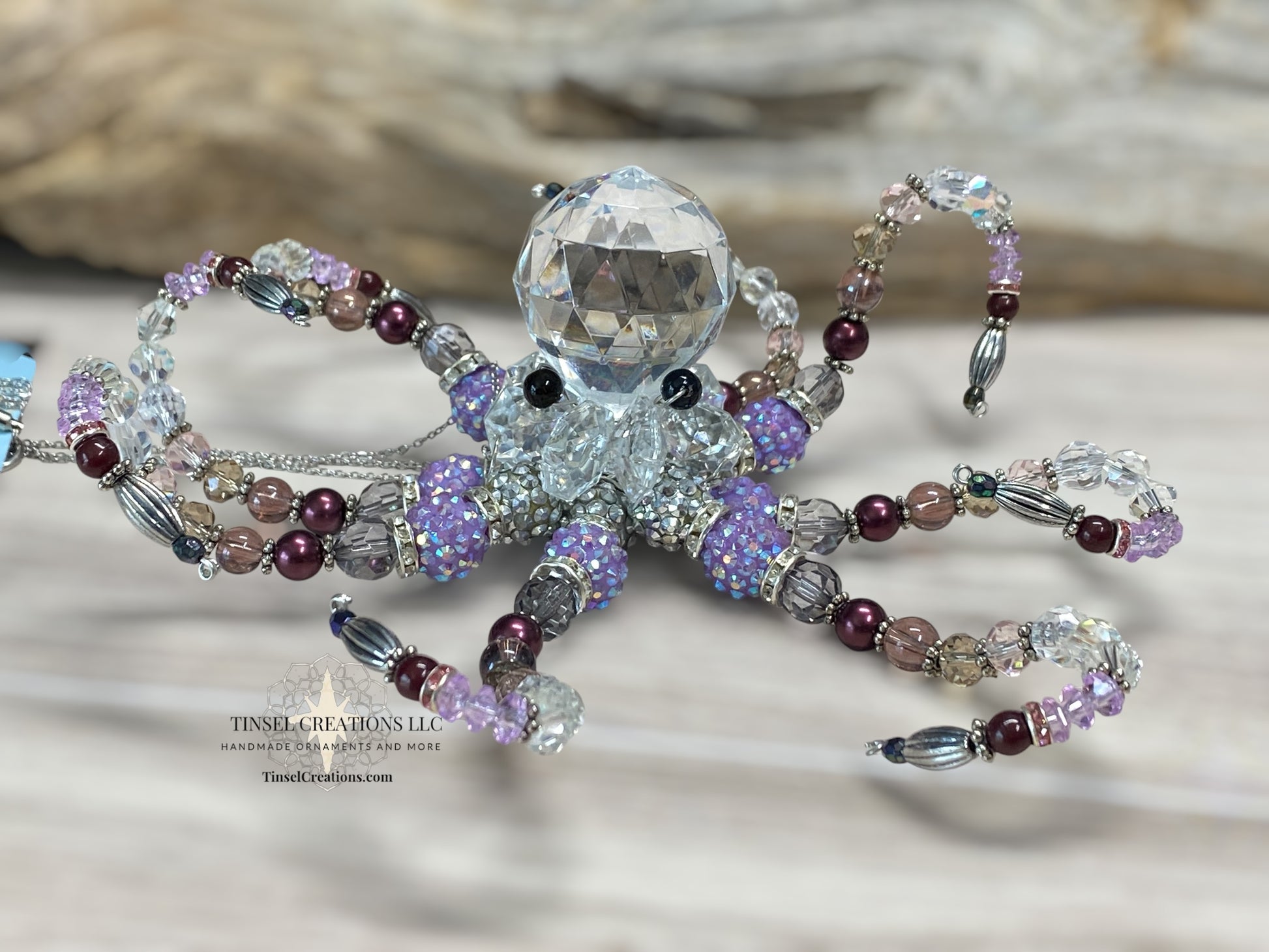 Decorative octopus ornament with bead detailing on a neutral background