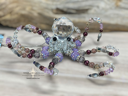 Decorative octopus ornament with bead detailing on a neutral background
