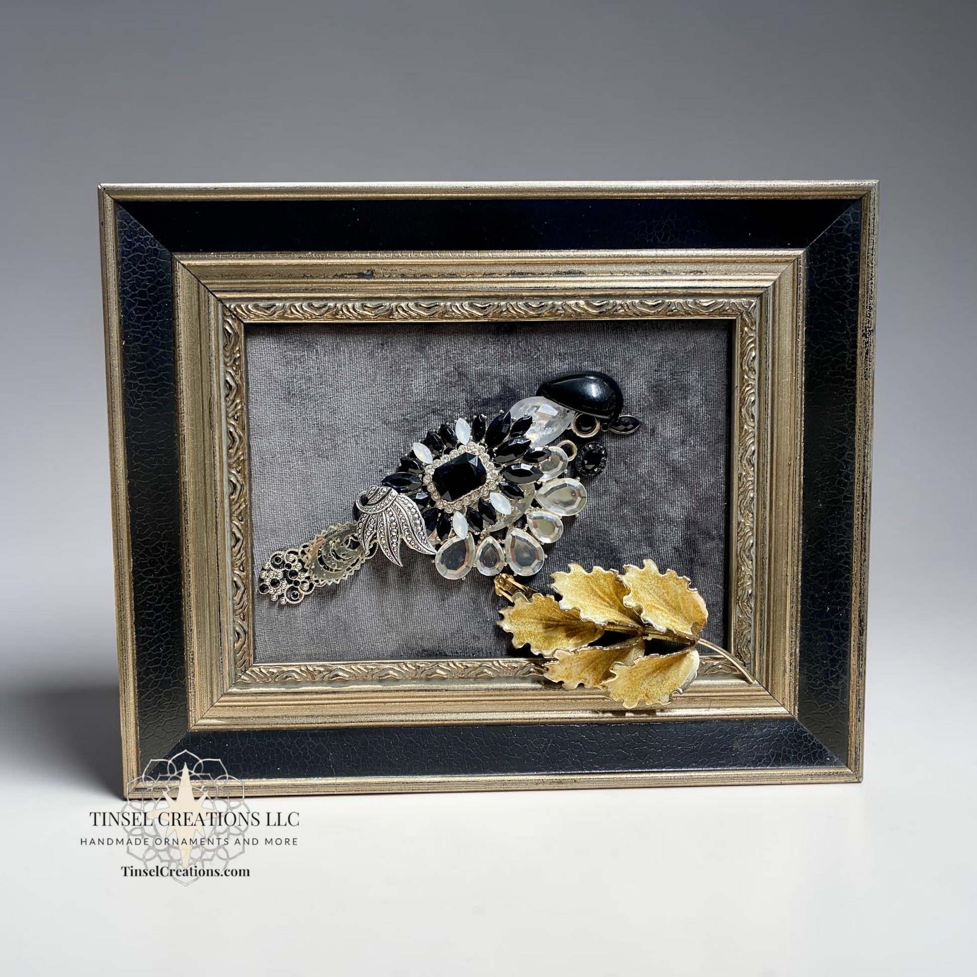 Decorative brooches and jewelry bird in a decorative frame with a gray background